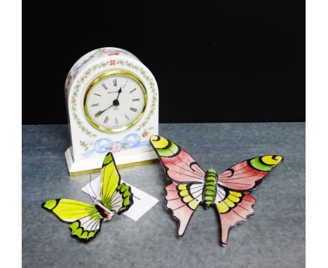 A Wedgwood 'Ribbon Cascade' patterned porcelain mantle clock, together with two Portuguese painted butterflies, (3) 