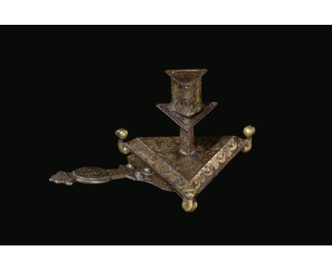 A forged iron and damascened brass table candlestick, France, early 17th century cm 26x15,5x12