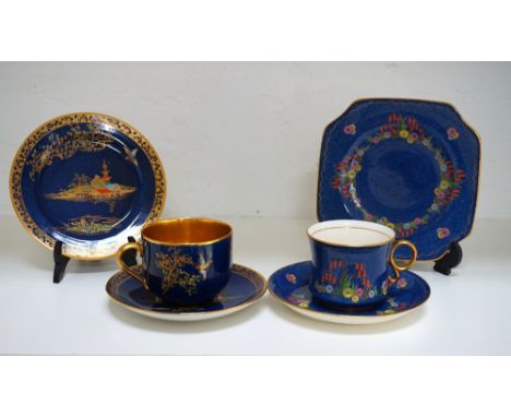TWO CARLTON WARE TRIOS
both circa 1920's and on blue grounds with gilt highlights, one painted with colourful flowers and the