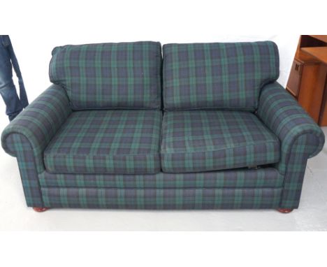 COMBINATION TWO SEAT SOFA BED
with loose cushions, covered in plaid, standing on squat turned supports, 171cm wide