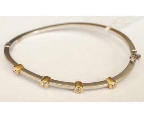 CZ SET EIGHTEEN CARAT GOLD BANGLE
the wavy formed bangle in white and yellow gold, approximately 7.8 grams
