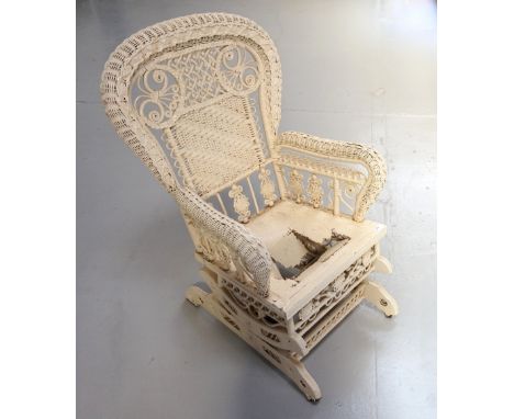 VINTAGE PAINTED WICKER ROCKING CHAIR
with decorative frame, raised on castors