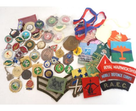 SELECTION OF SPORTING AND MILITARY BADGES
including a cased Scouts lapel badge, bronze, silver and other swimming badges, a 1