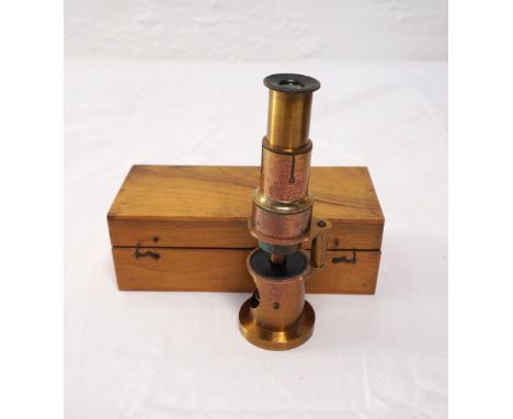 CASED BRASS MONOCULAR MICROSCOPE
with adjustable eyepiece and mirror light source, 15.5cm high