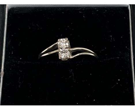 A 14ct two stone diamond ring. 1.6g gross, size K.