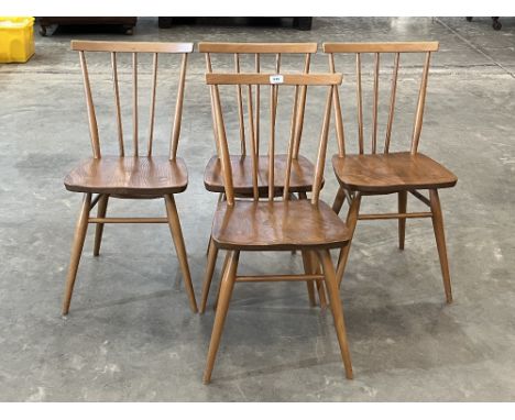 A set of four Ercol stick back kitchen chairs.