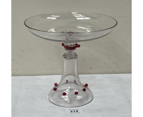 A glass tazza by James Powell and Sons, with applied ruby glass cabochons. 8½" diam x 7½" high.
