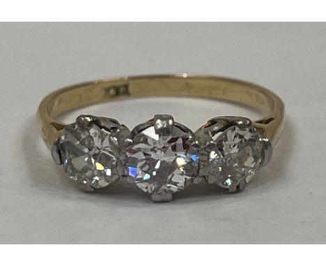 An 18ct and platinum three stone diamond ring. The three stones 1½ carats approx overall.