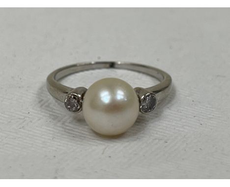 An 18ct pearl and diamond ring. 1.9g gross, size H.