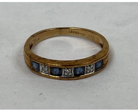 A seven stone sapphire and diamond channel set ring. In gold marked 375. 1g gross, size J.