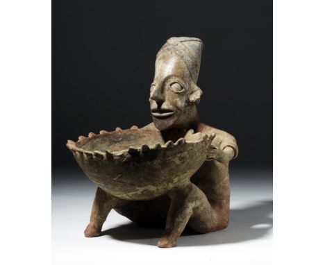 Pre-Columbian, West Mexico, Jalisco, ca. 300 BCE to 300 CE. A large seated pottery figure, holding a massive bowl on his knee