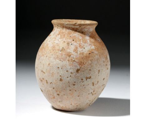 Ancient Egypt, Naqada II, ca. 3500 BCE. A Nile silt mud molded ovoid jar with a short neck, a slight rolled rim, and a rounde