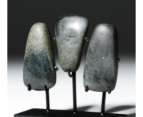 Pre-Columbian, Maya, probably Guatemala, Late Classic Period, 500 to 800 CE. A trio of very dark greenstone jade hand axes, n
