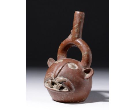 Pre-Columbian, Peru, Chimu/Inca, ca. 1200 to 1500 CE. A bichrome pottery stirrup vessel with a near-spherical body in the for