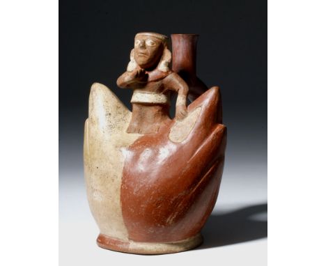 Pre-Columbian, North Coast Peru, Moche III-IV, ca. 200 to 500 CE. A bichrome stirrup vessel, hand painted in beautifully cont