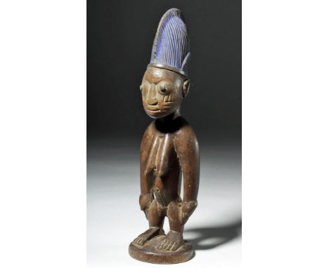 West Africa, Nigeria, Yoruba peoples, ca. early 20th century CE. A female Ere Ibeji twin figure, hand carved to represent a d