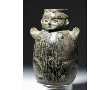 Pre-Columbian, North Coast Peru, Chimu, ca. 1000 to 1400 CE. A hand-built blackware vessel depicting an anthropomorphosed fig