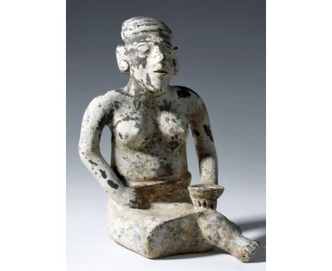 Pre-Columbian, West Mexico, Jalisco, ca. 300 BCE to 300 CE. This is a large pottery figure, covered overall with white slip. 