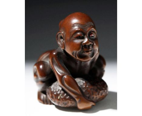 Japan, late Edo to Meiji Period, ca. 1800 to 1912 CE. This is a beautiful dark boxwood netsuke with heavily detailed, realist