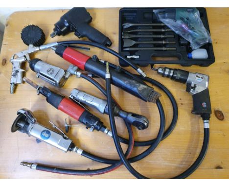 A quantity of compressed air tools, including cutters and ratchets.  