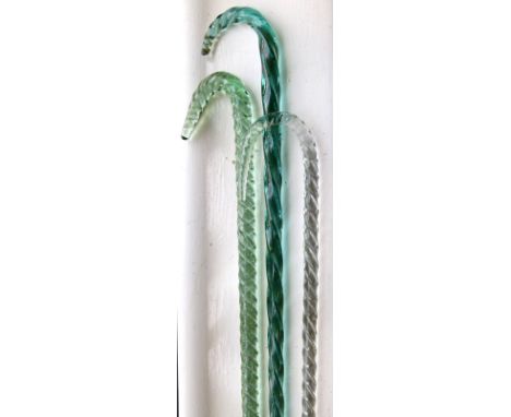 Two 19th Century Nailsea type green glass walking sticks, together with a similar clear glass stick   Condition: 