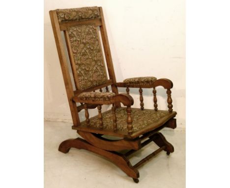 American walnut rocking chair having floral tapestry finish upholstery   Condition: 