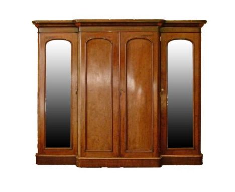 Victorian mahogany breakfront wardrobe, the centre section having a pair of arched blind panel doors enclosing brushing slide