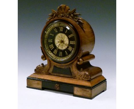 Late 19th Century walnut and ebonised cased mantel clock, having a carved shell and bulrush pediment, conforming dolphin deco