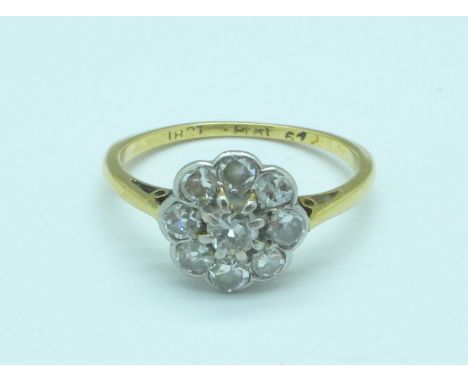 An 18ct gold, platinum set diamond daisy cluster ring, 2.4g, M