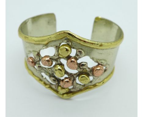 A 1980's copper and brass designer bangle marked Drate