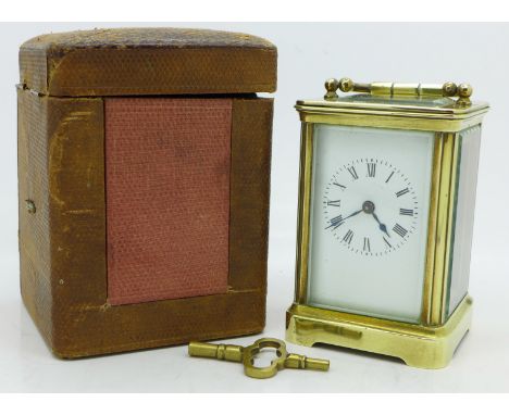 A brass and glass carriage clock, cased, with key, height of case 9cm