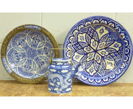 A blue and white oriental teapot and two blue and white chargers or bowls, one a/f