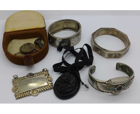 A Harley-Davidson bangle marked HD Inc., 1994, two 925 silver bangles, a carved pendant, etc.