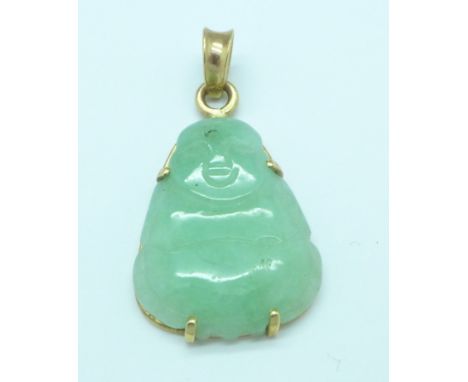 A yellow metal and jade Buddha pendant