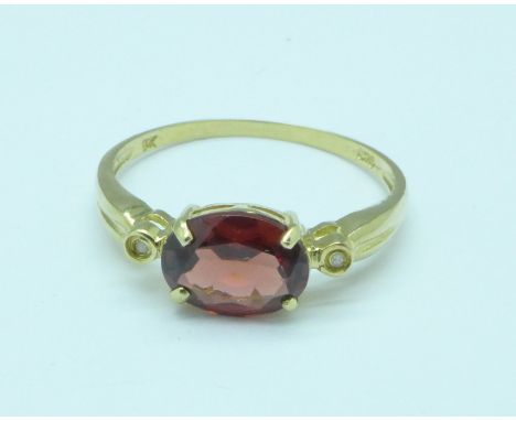 A 9ct gold, garnet and diamond ring, 1.4g, O