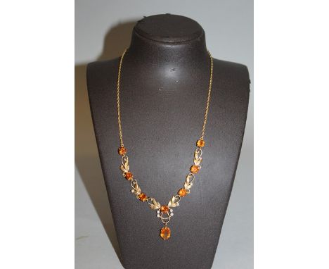 AN EDWARDIAN CITRINE AND PEARL NECKLACE set in yellow gold.
