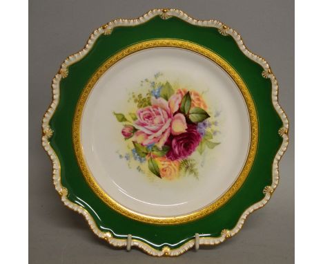 A ROYAL WORCESTER PLATE painted with roses inside an acid etched inner border and gadroon rim by Ernest Barker, signed, date 