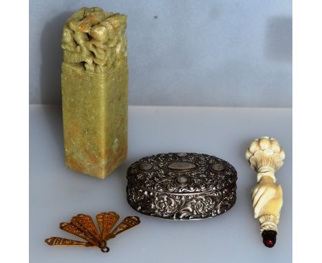 AN OVAL SILVER SNUFF BOX, CARVED IVORY HAND, small metal fan and Chinese soapstone seal (4).