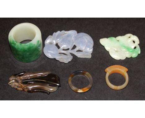 A CHINESE JADE-LIKE ARCHER’S RING, 1.25in diameter; together with five other small jade-like pieces. (6)