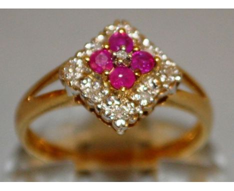 A DIAMOND AND GARNET SQUARE DRESS RING set in 9ct gold.