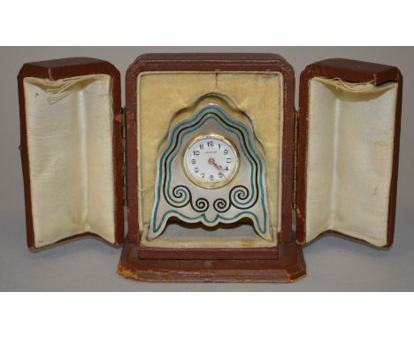 A ZENITH SILVER AND BLUE ENAMEL SHAPED CARRIAGE CLOCK on bracket feet, 2.25ins high, in leather case.