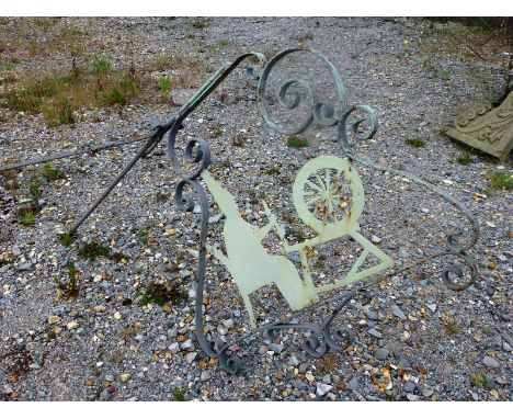 A WROUGHT IRON SIGN BRACKET.