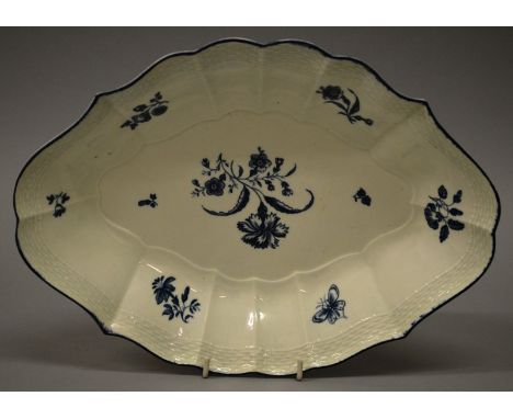 AN 18TH CENTURY GOOD WORCESTER DISH with basket weave moulding painted in blue under-glaze with flowers and a butterfly under