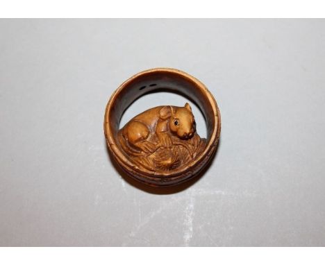 A JAPANESE FAUX IVORY NETSUKE OF A RAT IN A BARREL, 1.25in diameter.