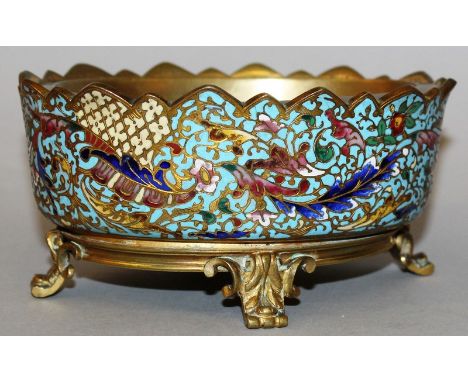A 19TH CENTURY FRENCH ORMOLU MOUNTED AND CHAMPLEVE ENAMEL OVAL DISH supported on four curving legs 5.5ins wide.