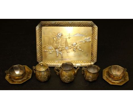 AN EARLY 20TH CENTURY JAPANESE GILDED & SILVERED SOFT METAL MINIATURE PART TEA SERVICE, comprising a tray, a teapot, a sugar 