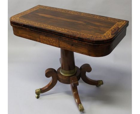 A GOOD REGENCY ROSEWOOD CARD TABLE with superb quality banding and inlay, fold over swivel top with green baize interior, cen