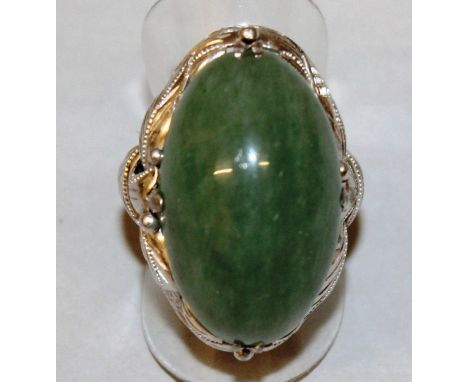 A GOOD 18CT WHITE GOLD AND JADE RING.