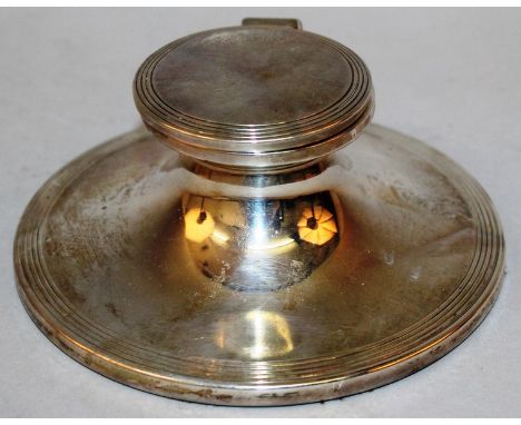 A GEORGE V CIRCULAR CAPSTAN INKWELL, 5ins diameter, with loaded base, lift up top and white porcelain ink pot. Sheffield 1926