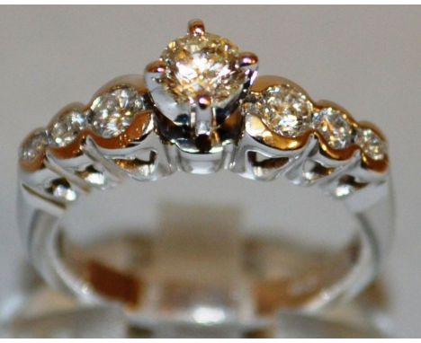 A SEVEN STONE DIAMOND RING, central stone flanked by three diamonds, set in 18ct white gold.